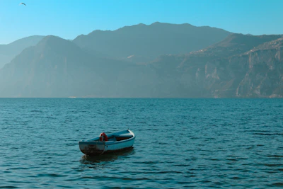 a small boat floating on top of a large body of water