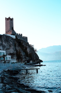 a castle on a cliff next to the ocean