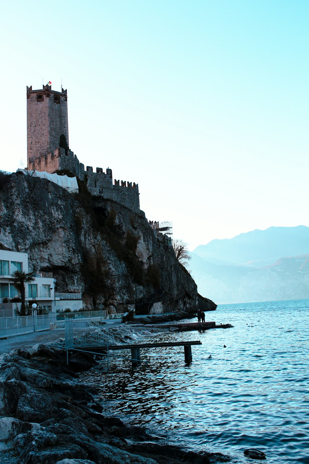 a castle on a cliff next to the ocean