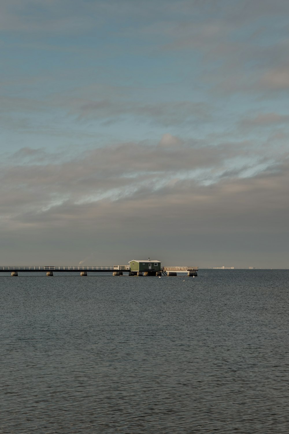 a large body of water with a bridge in the distance