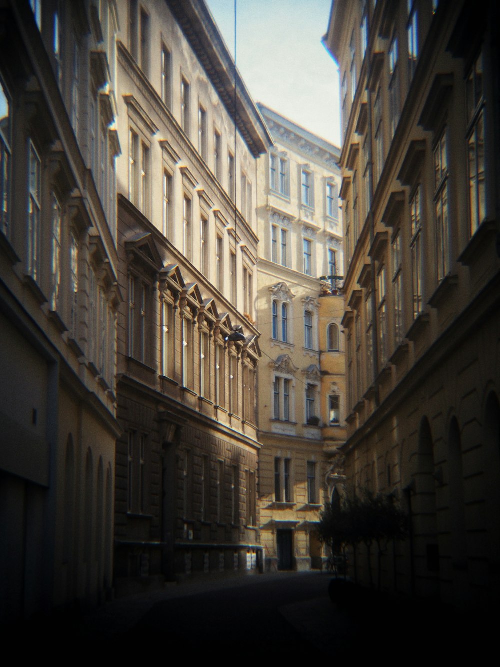 a narrow city street lined with tall buildings