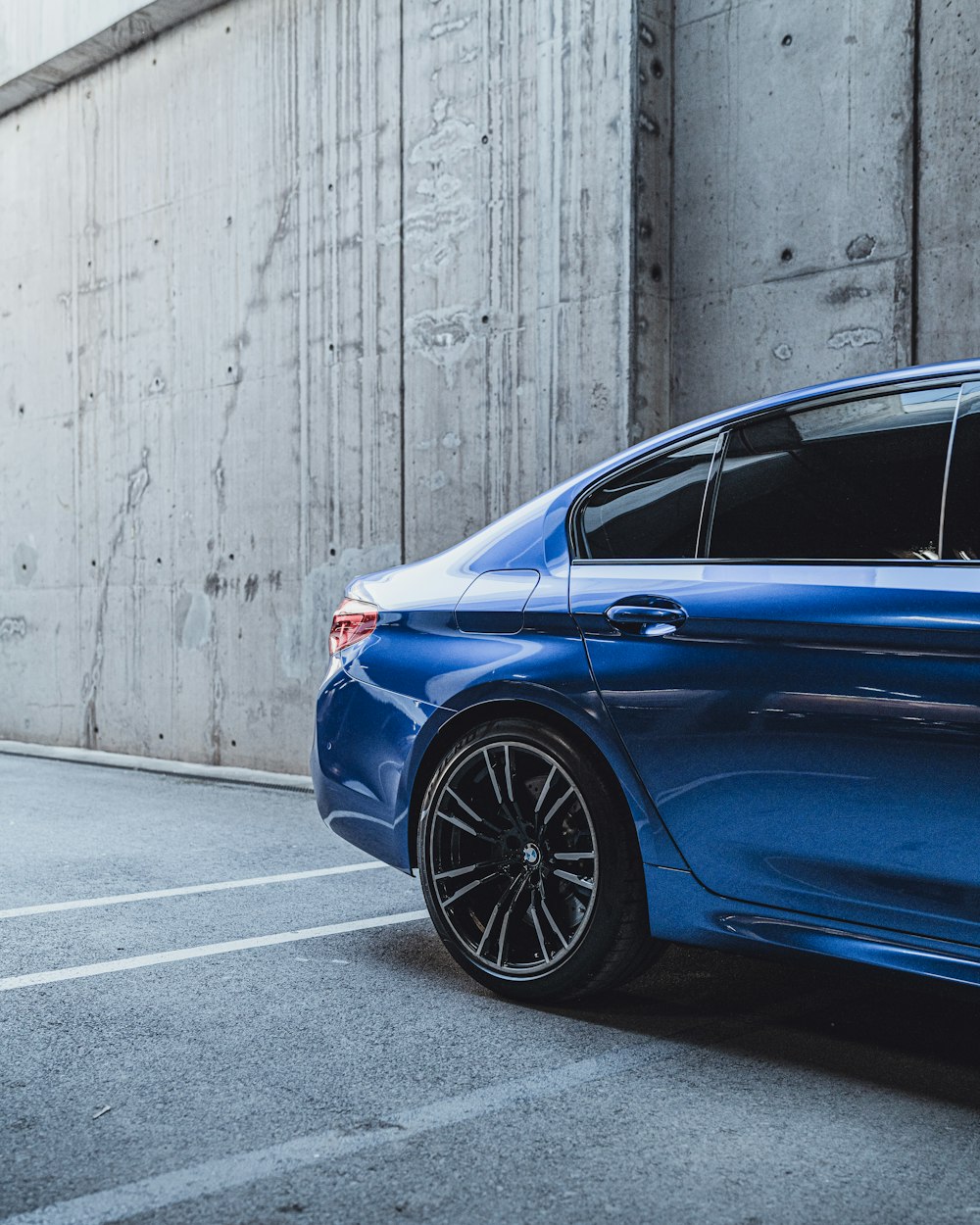 a blue car parked in front of a building