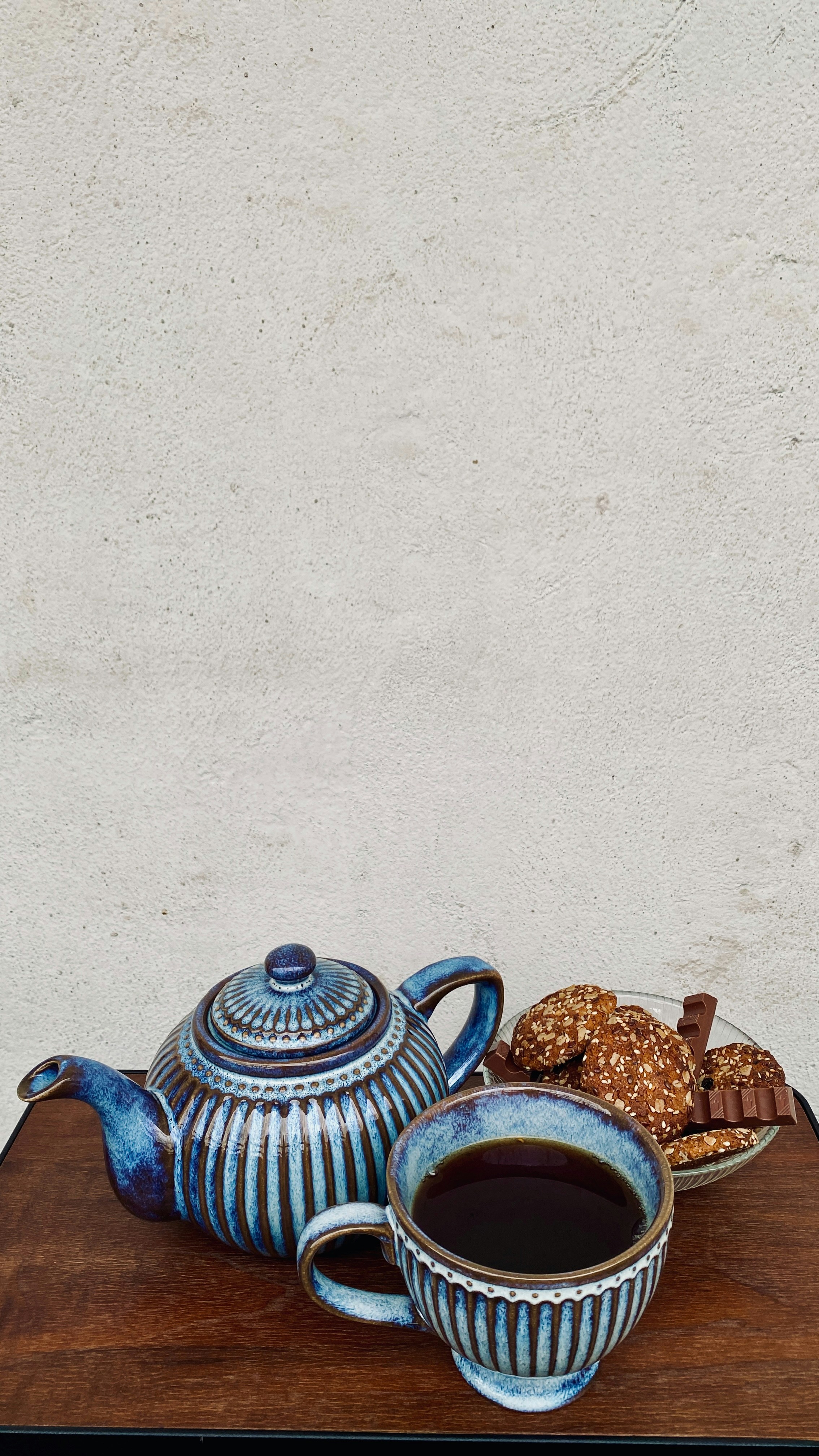 a cup of coffee and a plate of cookies on a table