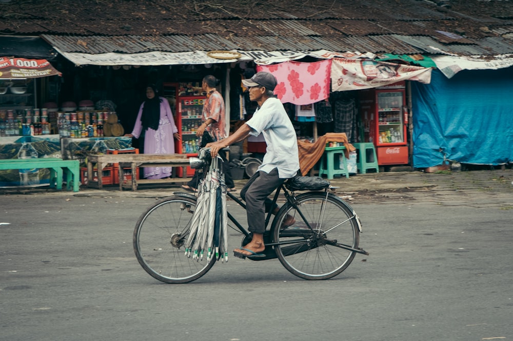 a man riding a bike down a street