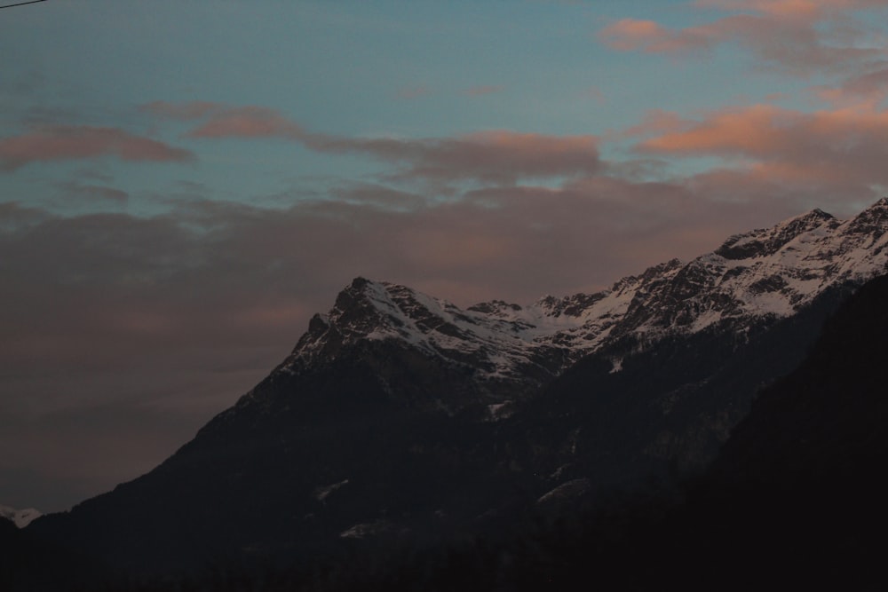 a view of a snowy mountain at sunset