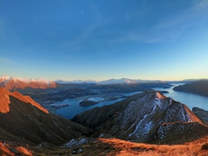 a view of a mountain range with a lake and mountains in the background