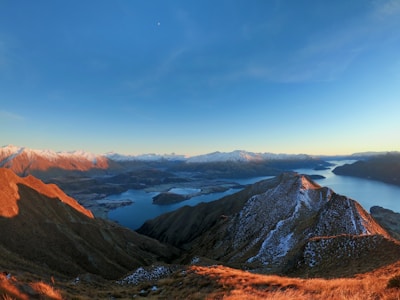a view of a mountain range with a lake and mountains in the background