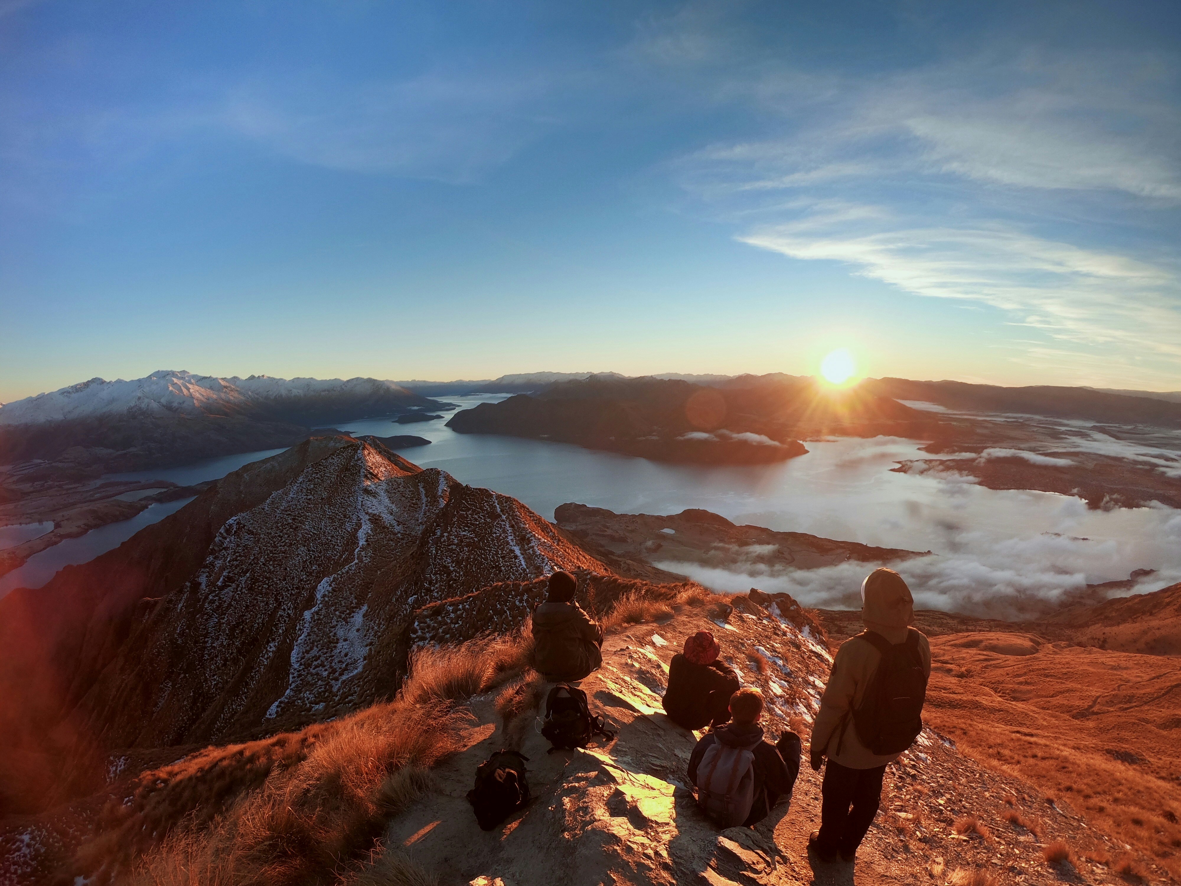 Friends looking at sunrise at Roy's Peak in New Zealand