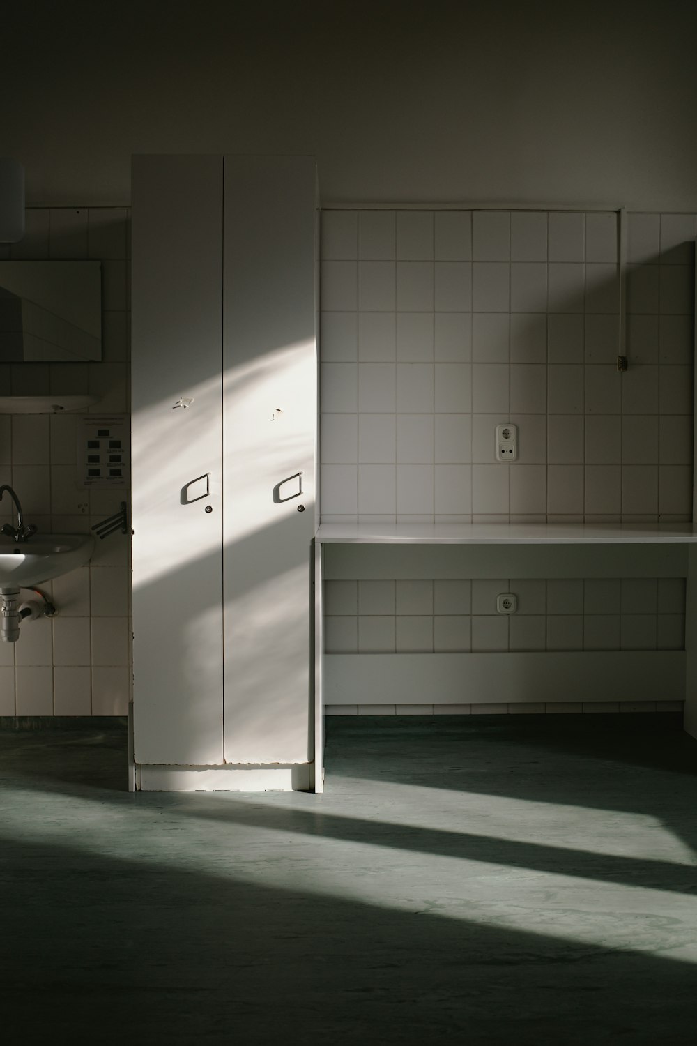 a bathroom with a sink, cabinets and a mirror