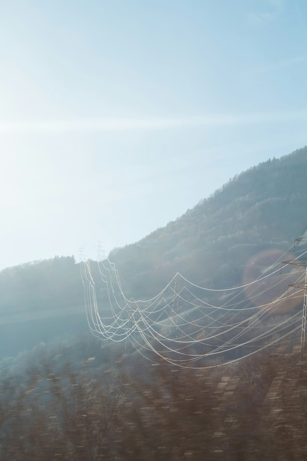 a blurry photo of power lines on a mountain