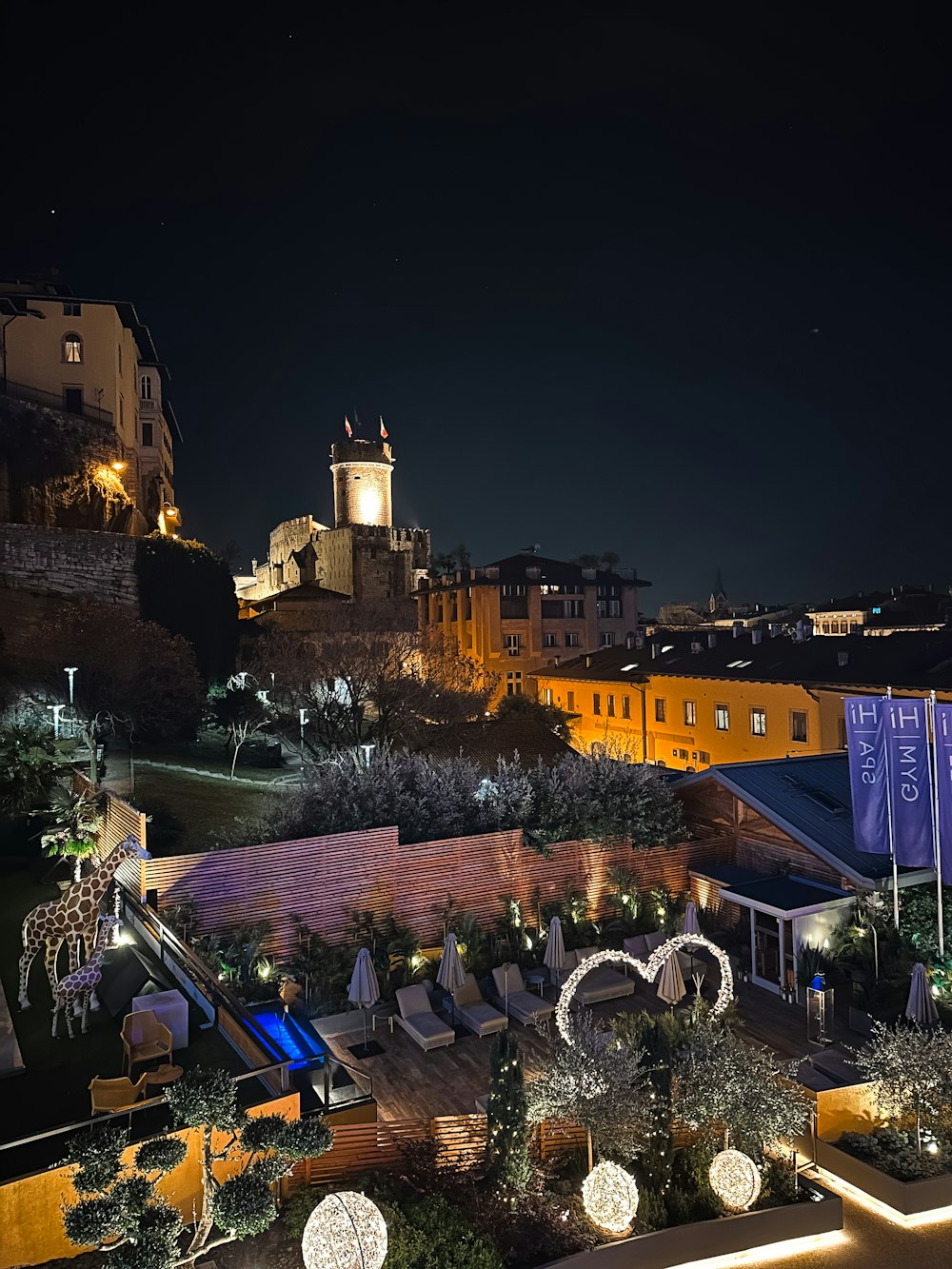 a night time view of a city with a clock tower