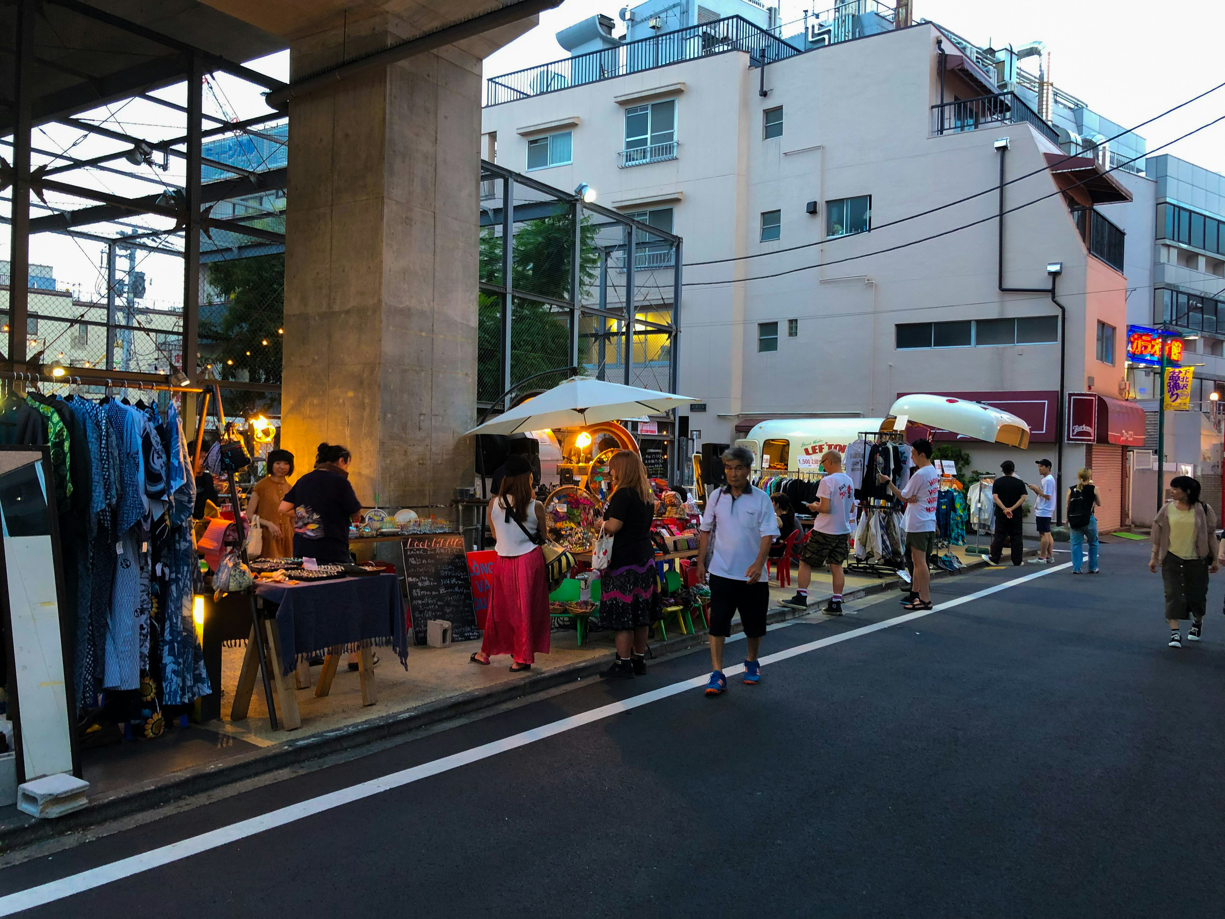 vintage clothing stores and indie cafes on a narrow pedestrian street in Shimokitazawa Tokyo with young people walking