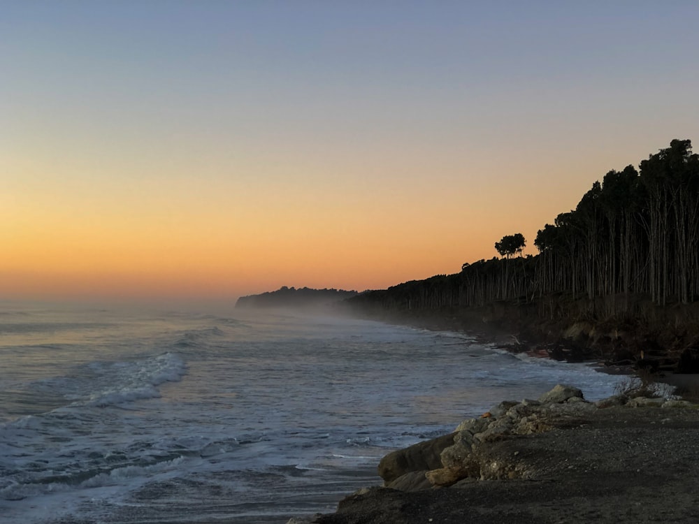 a view of a beach with waves coming in to shore