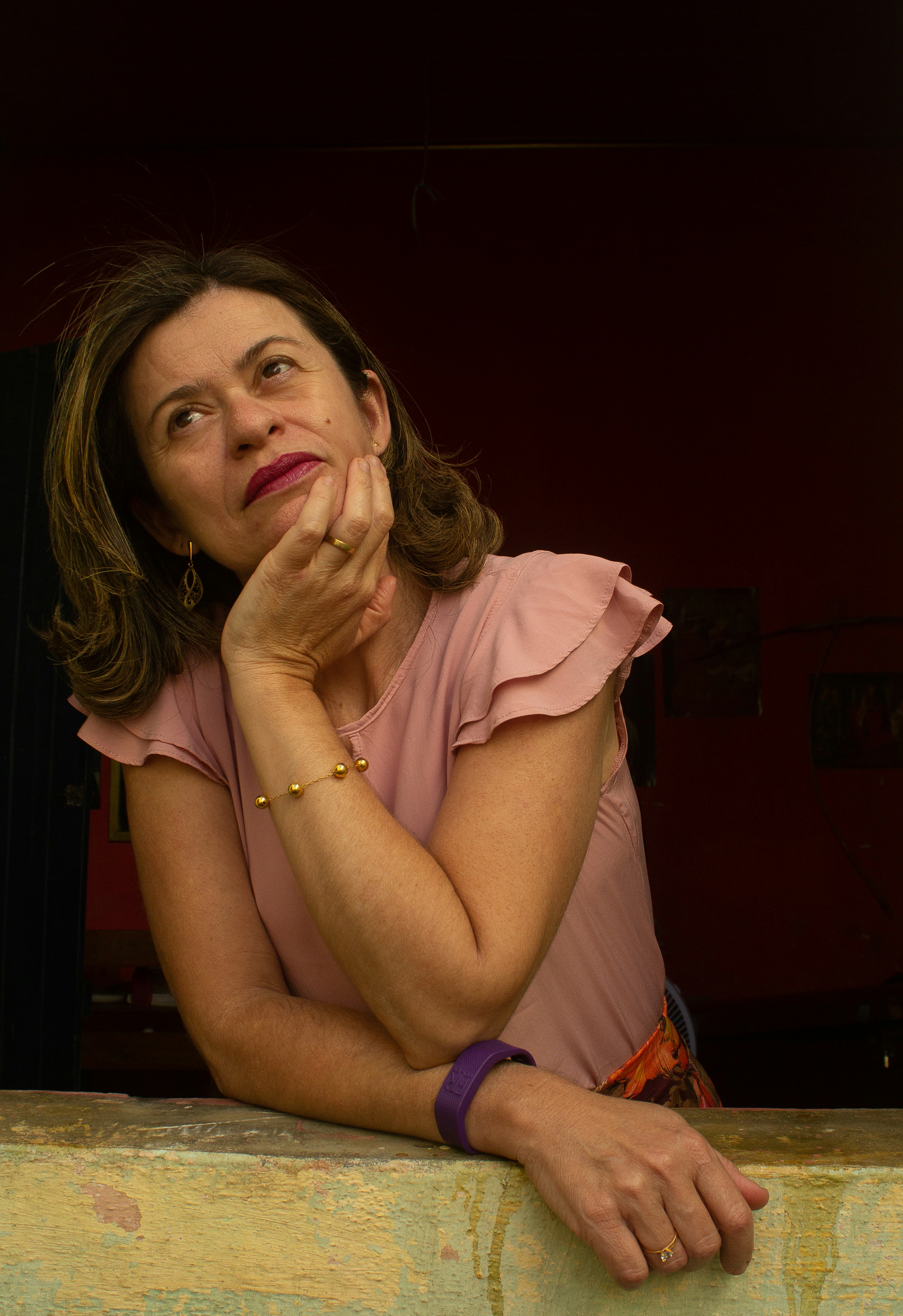 Woman deep in thought, with subtle lunar cycle imagery in the background, symbolizing cyclical overthinking.