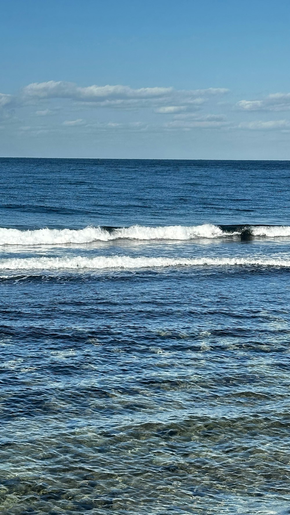 a person riding a surfboard on a wave in the ocean