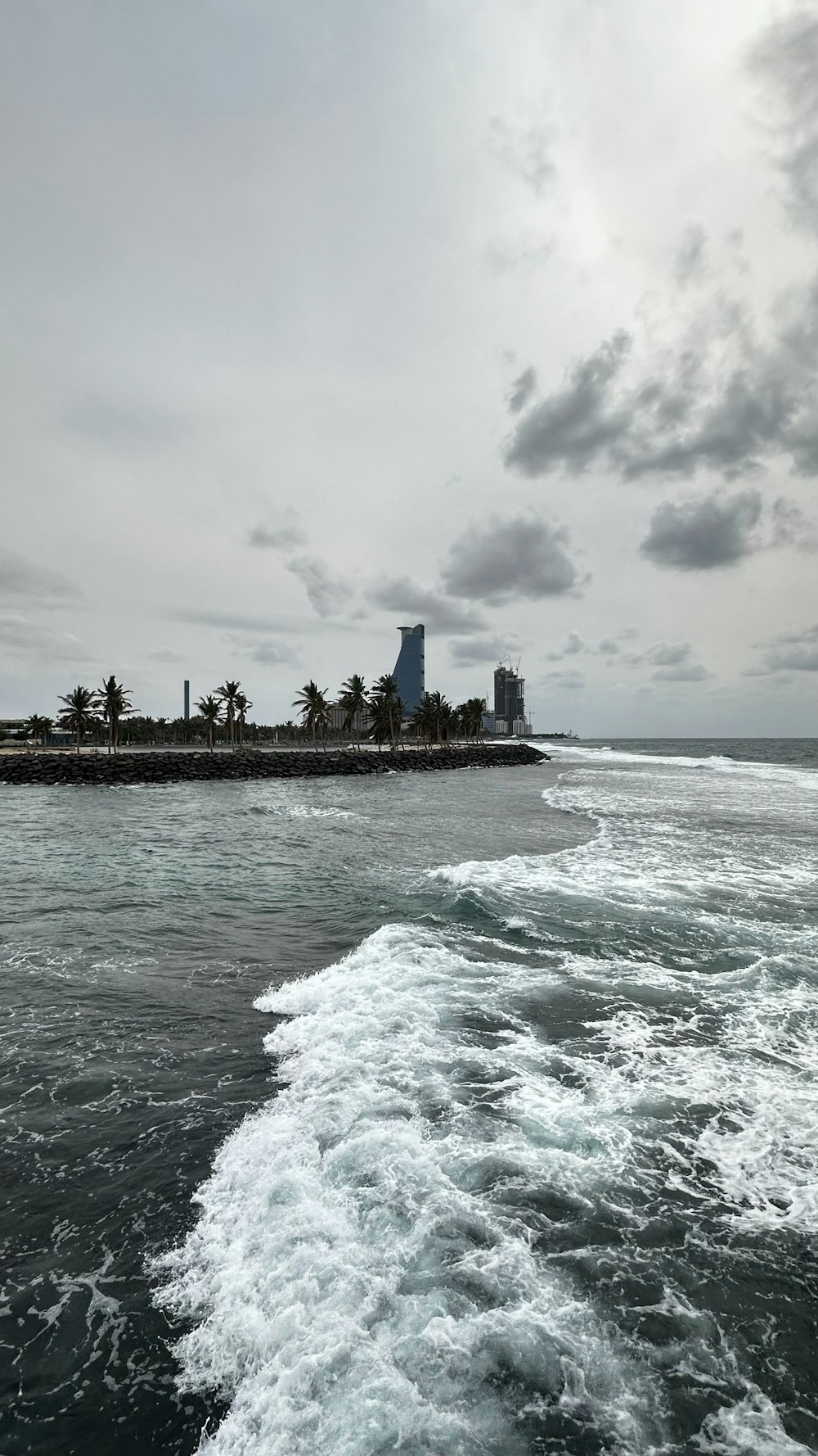 a body of water with a city in the background