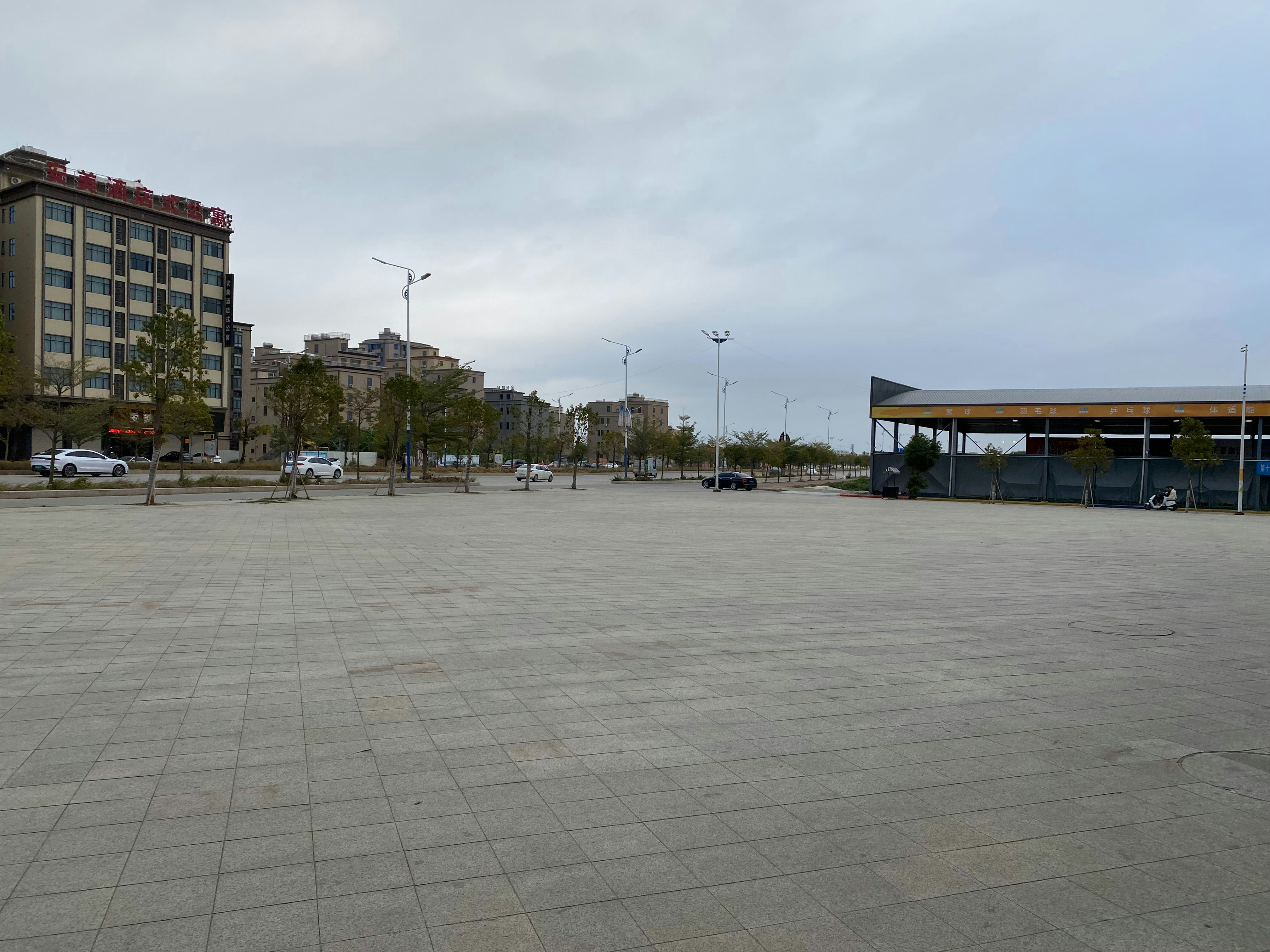 an empty parking lot with a building in the background