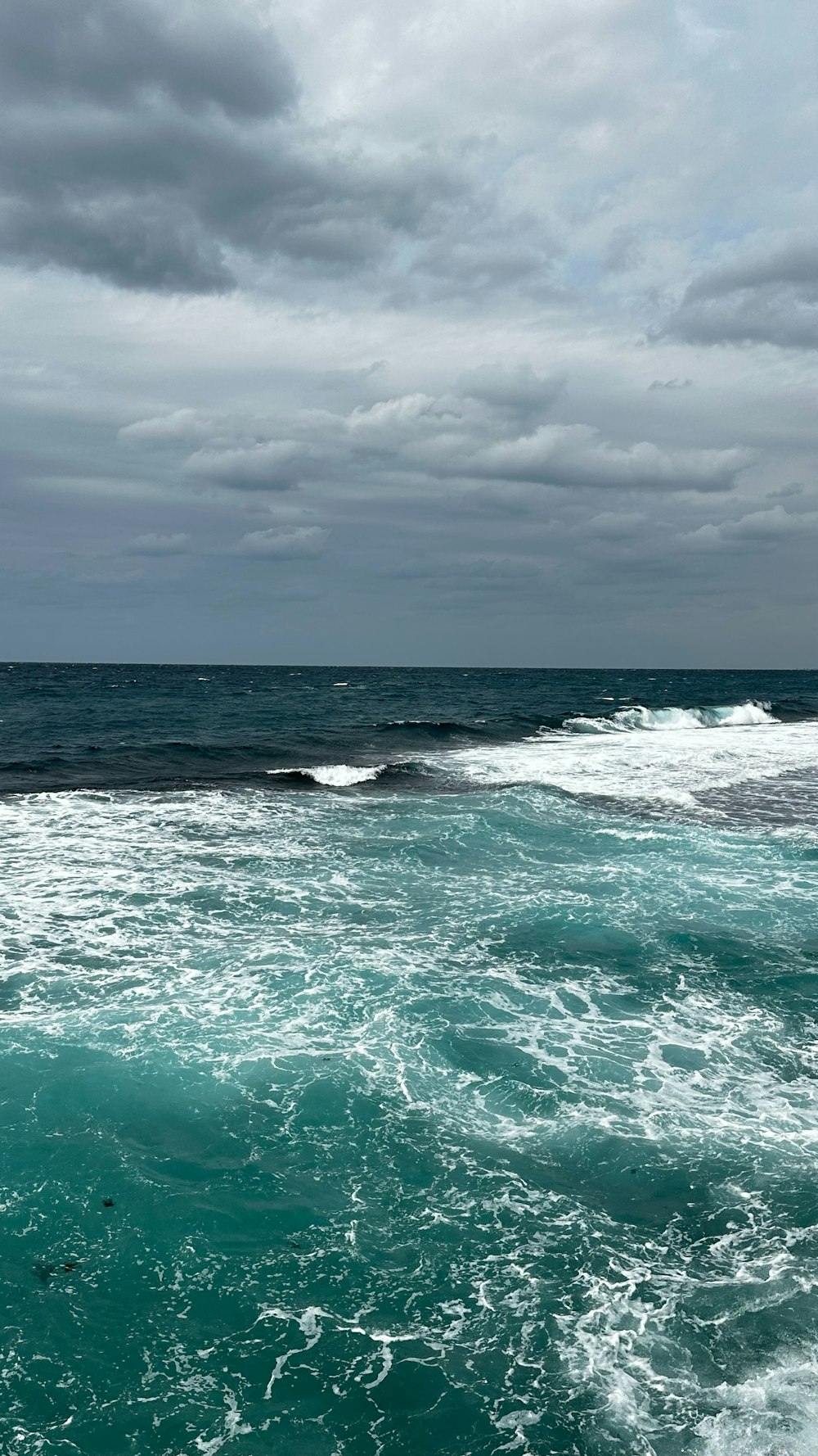 a person riding a surfboard on a wave in the ocean