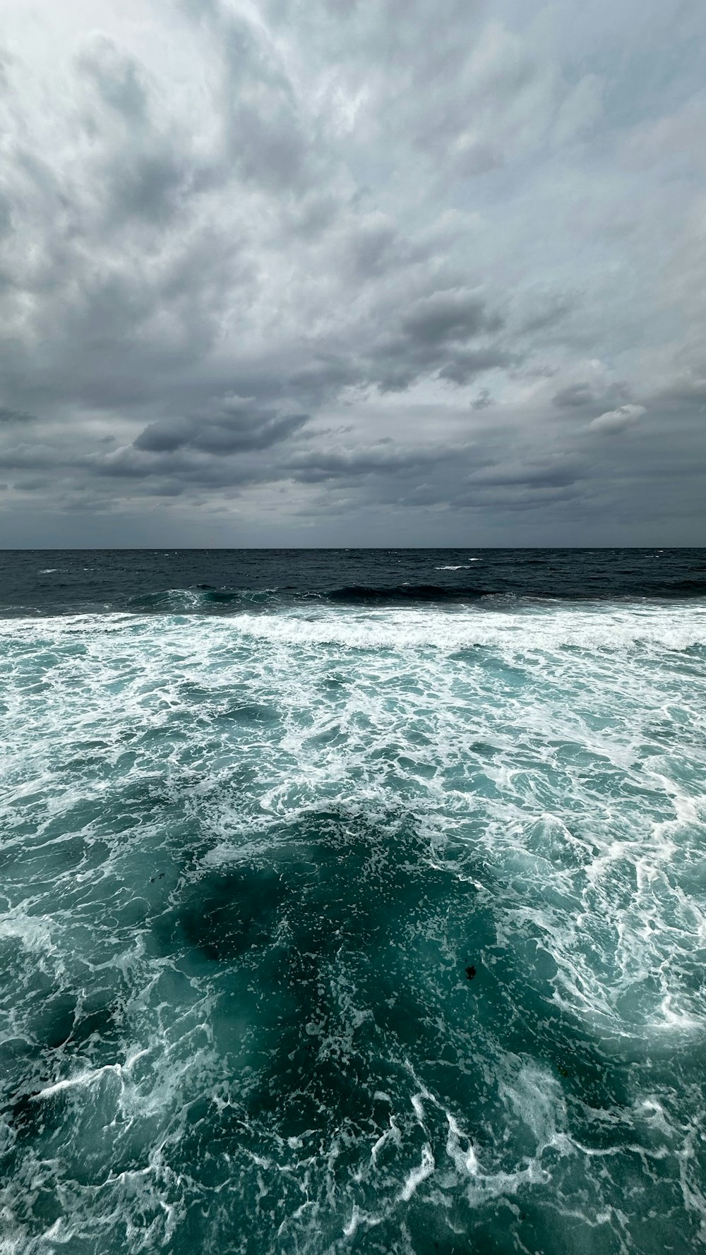 a view of the ocean from a boat on a cloudy day