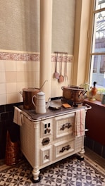 an old fashioned stove with pots and pans on top of it