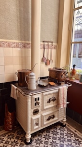 an old fashioned stove with pots and pans on top of it