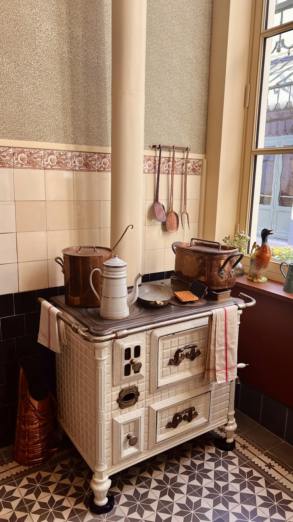 an old fashioned stove with pots and pans on top of it