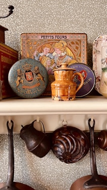 a shelf filled with pots and pans on top of a wall