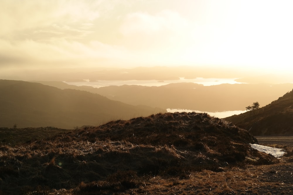 the sun is setting over a mountain range