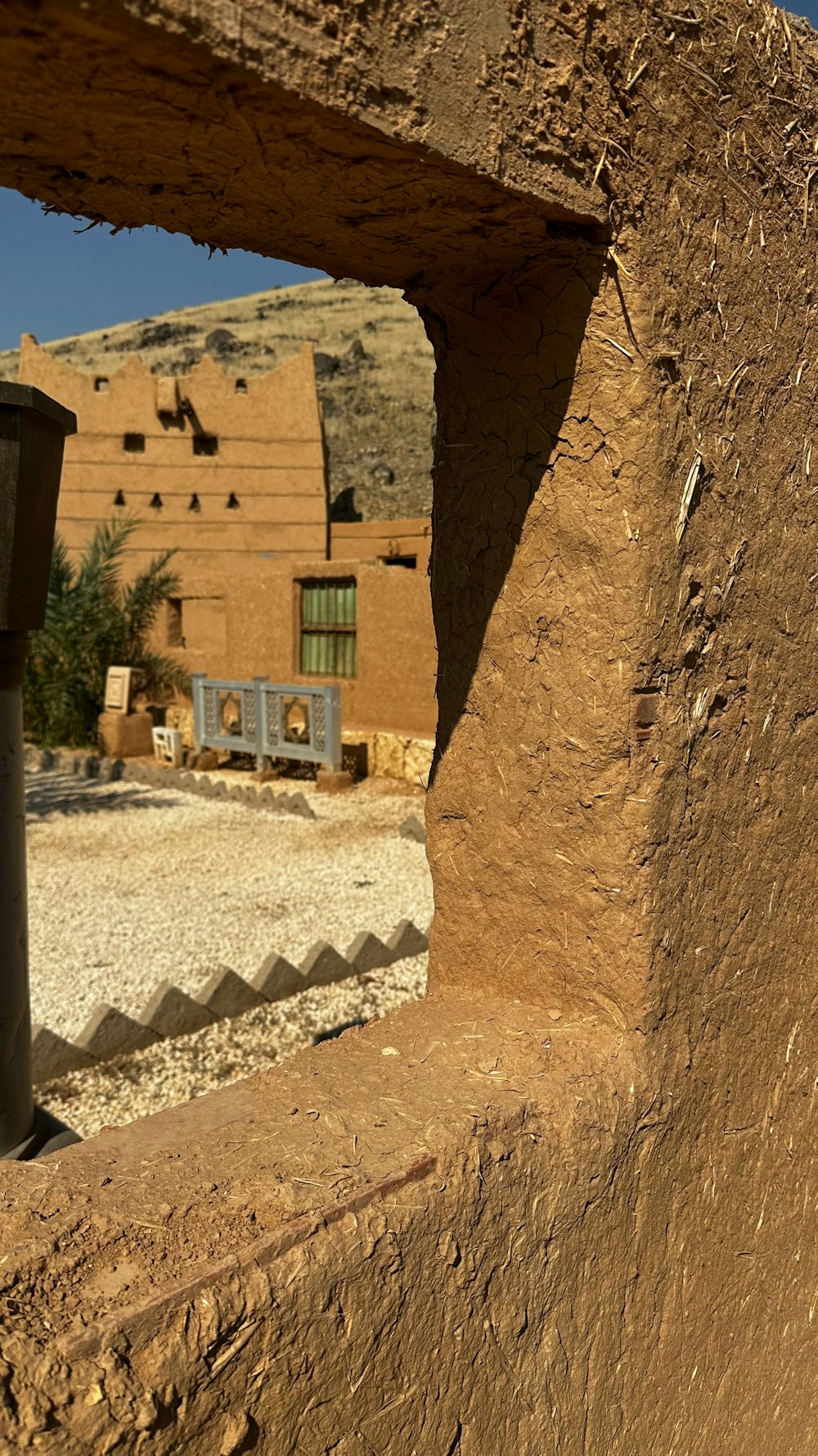 a view of a building through a hole in a wall