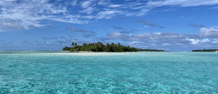 A small island in the turquoise ocean off the coast of Tahiti