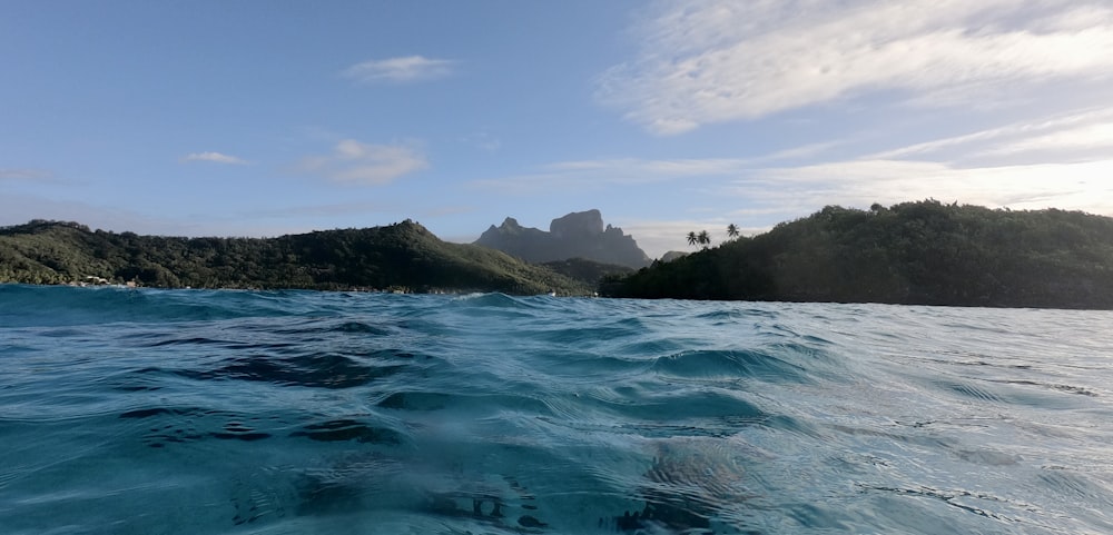 a body of water with a small island in the background