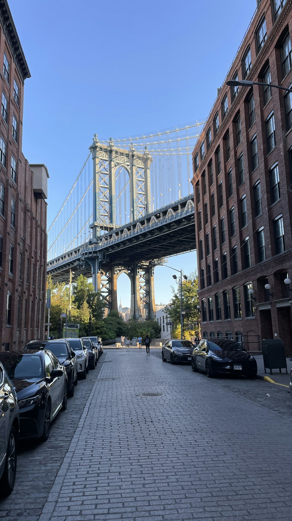 a city street with a bridge in the background