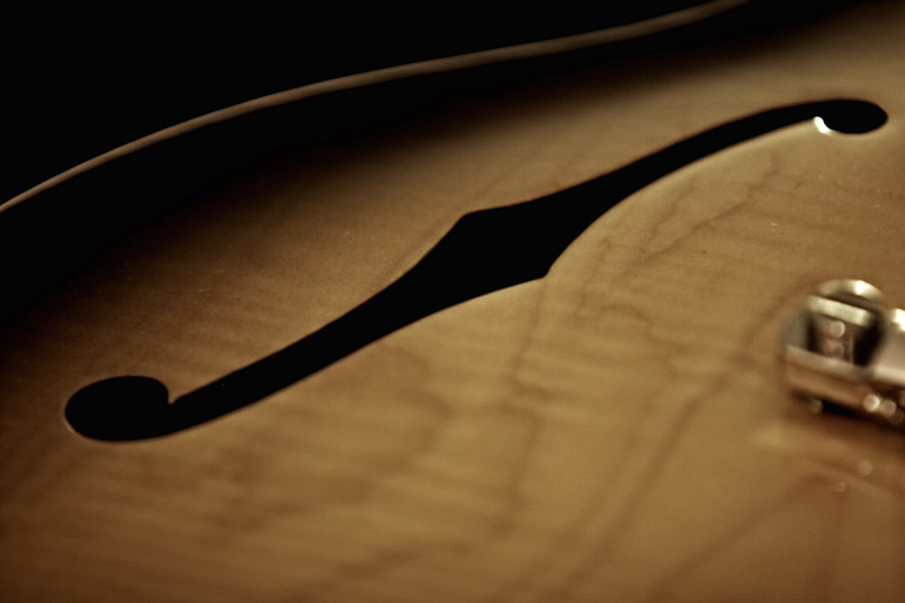 a close up of a guitar neck with a guitar pick