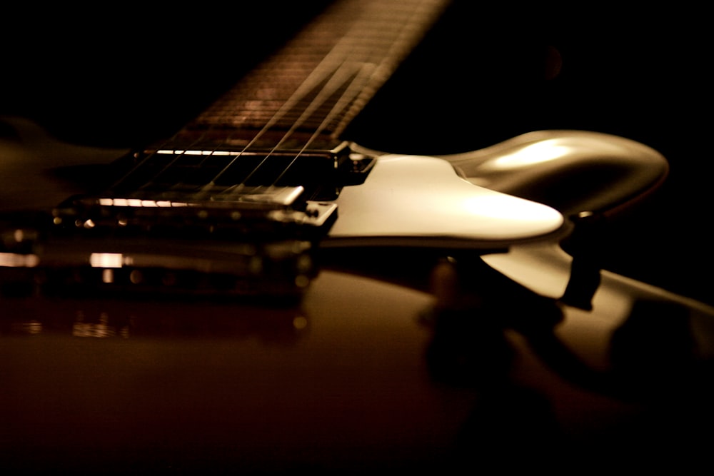 a close up of a guitar with a black background