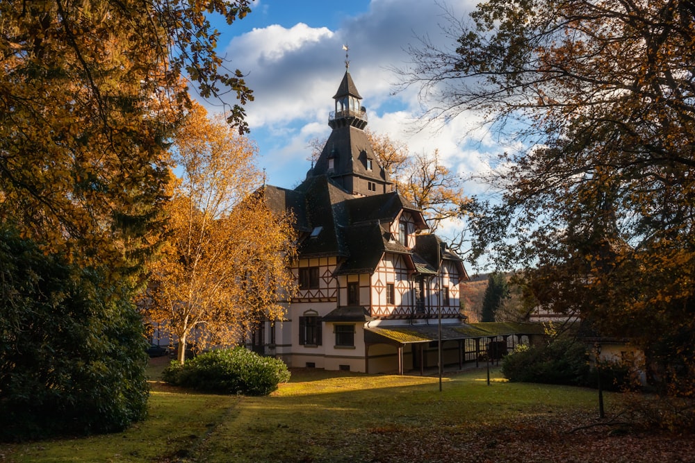 a large building with a steeple surrounded by trees