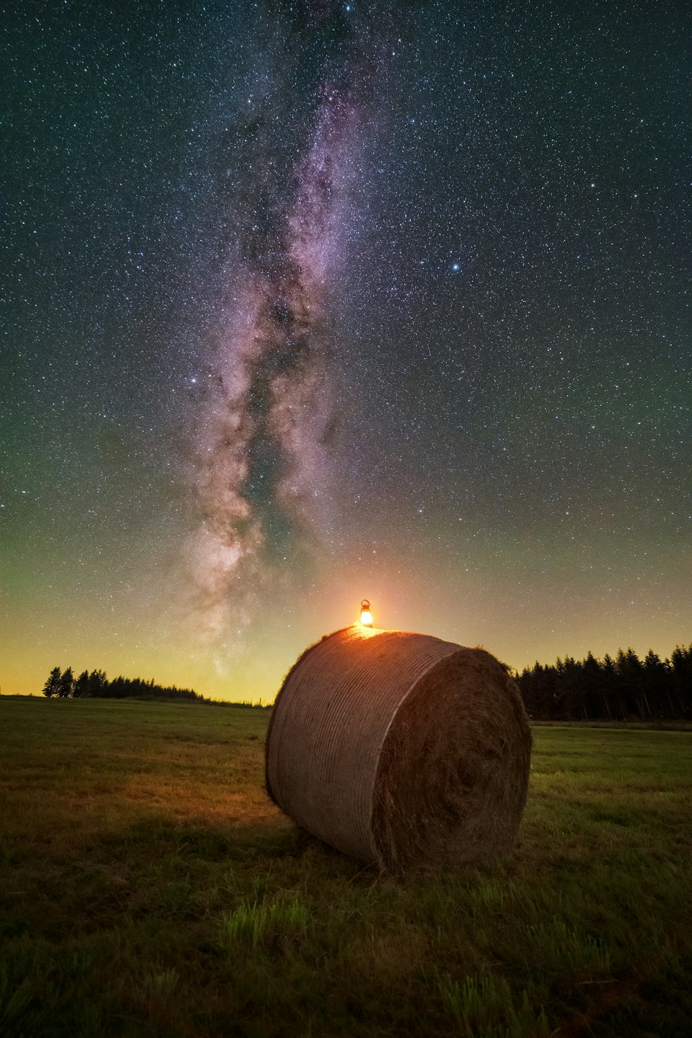 a hay bale in a field with the milky in the background