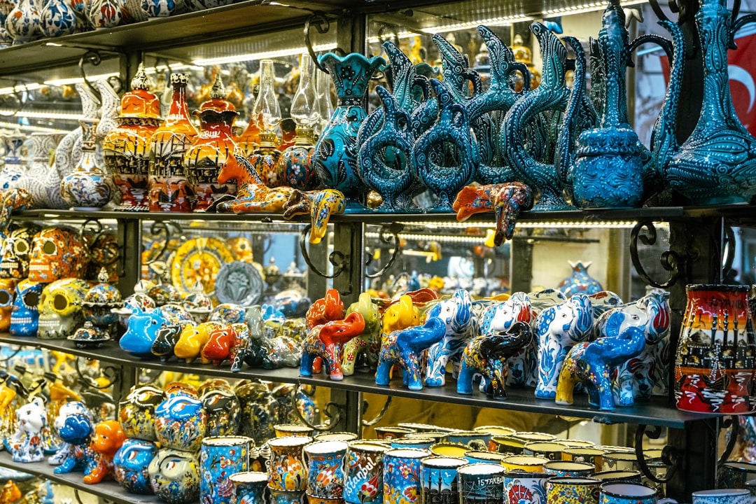 a display case filled with lots of colorful vases,