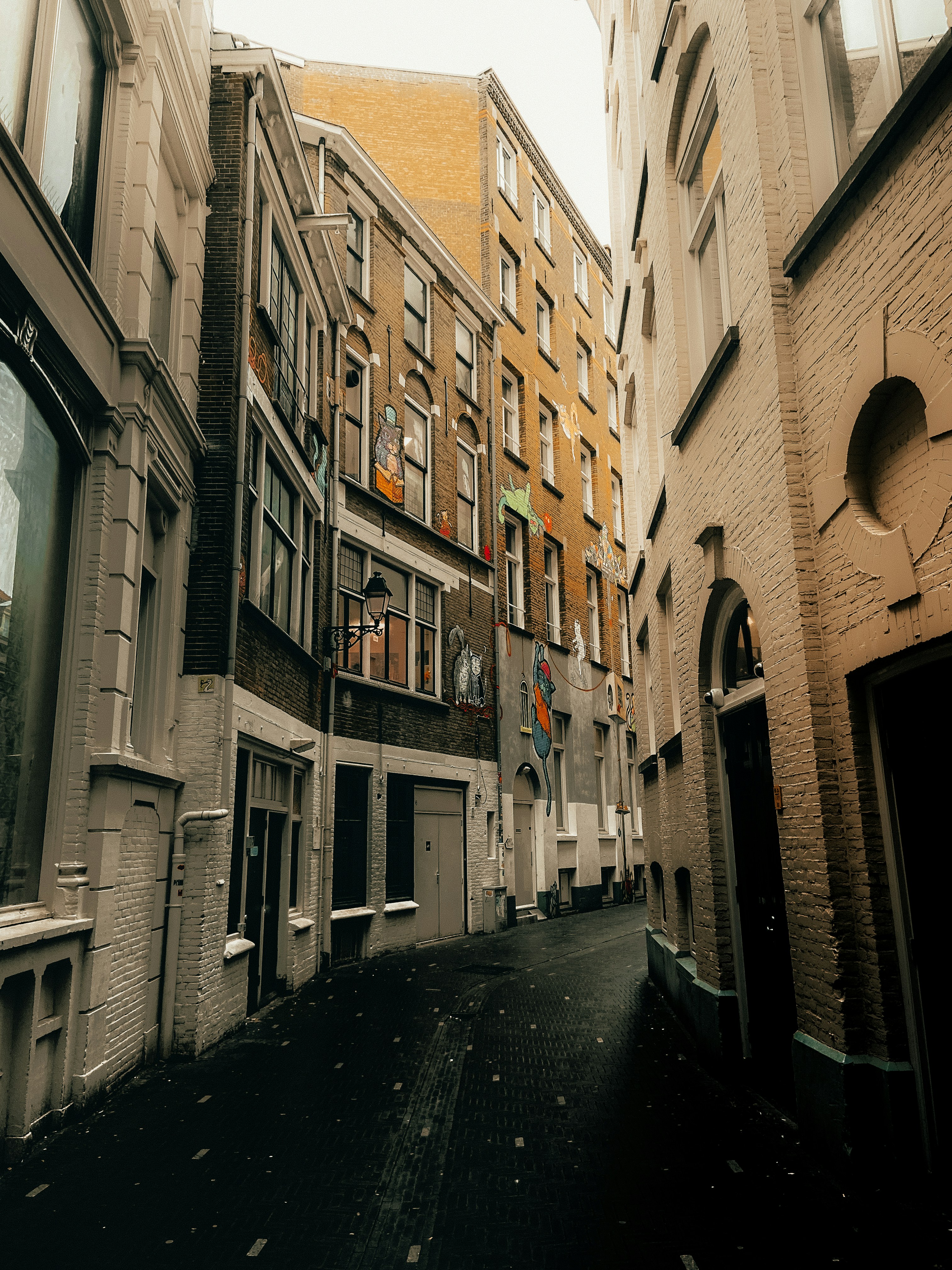 a narrow city street lined with tall buildings