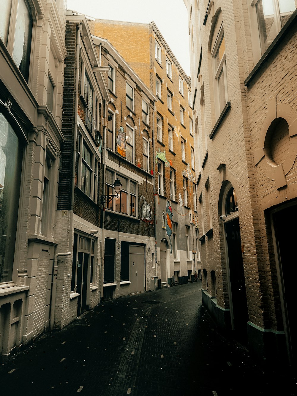 a narrow city street lined with tall buildings