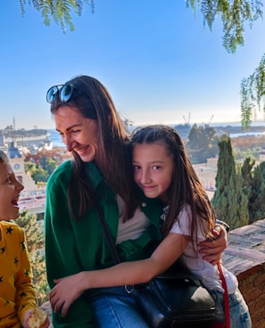 a woman and two children sitting on a bench