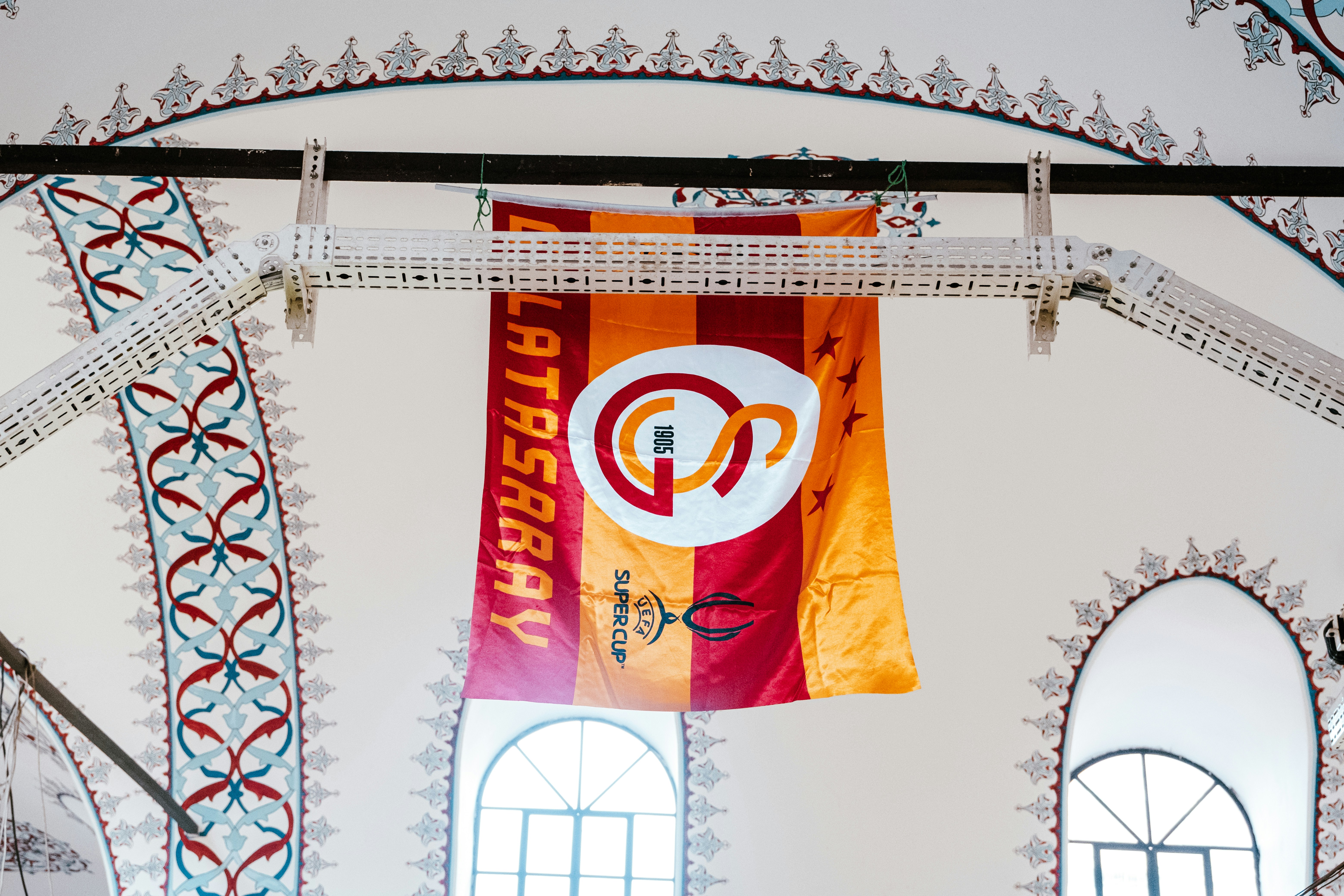 a flag hanging from a ceiling in a building