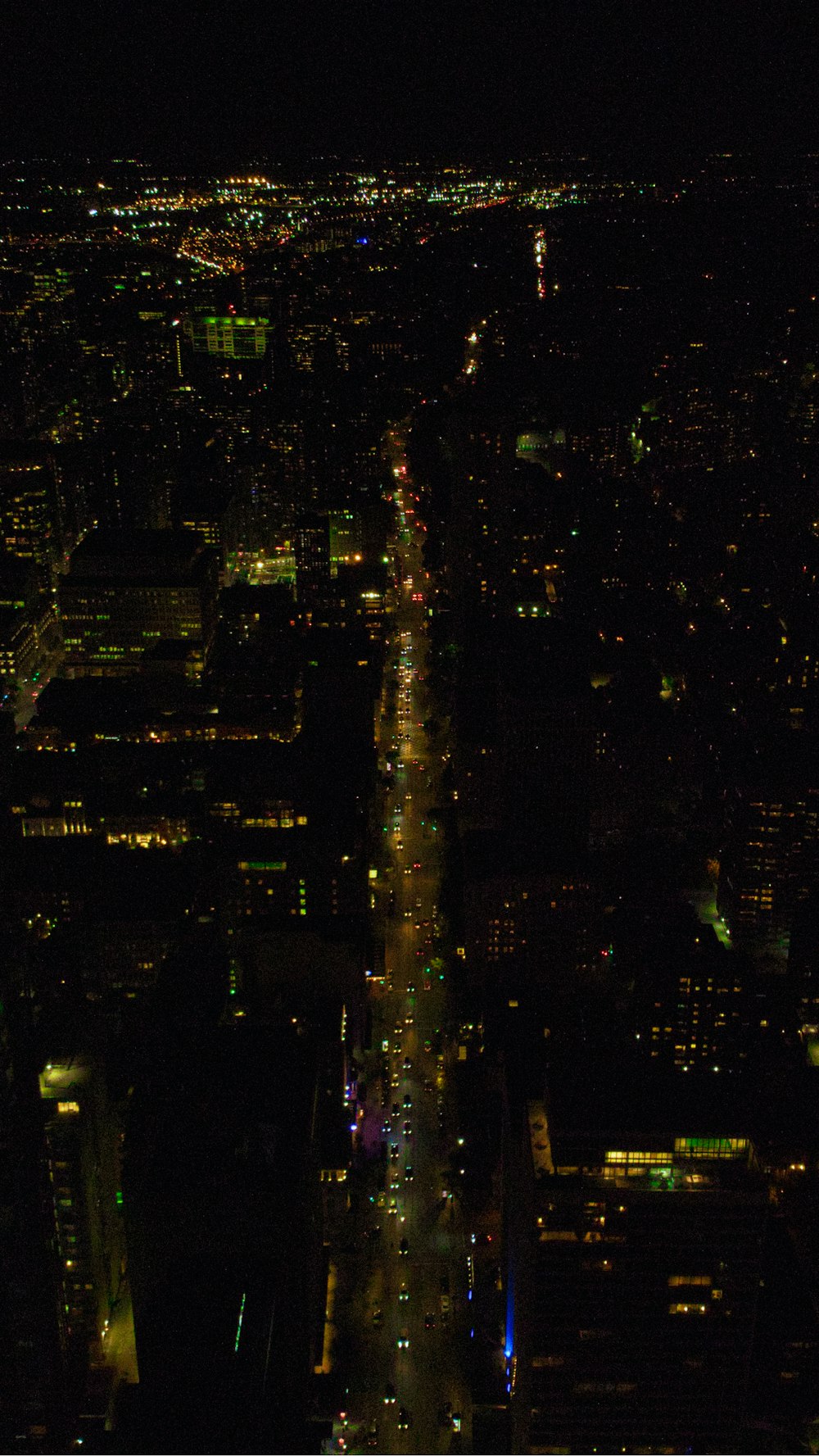 a view of a city at night from the top of a building