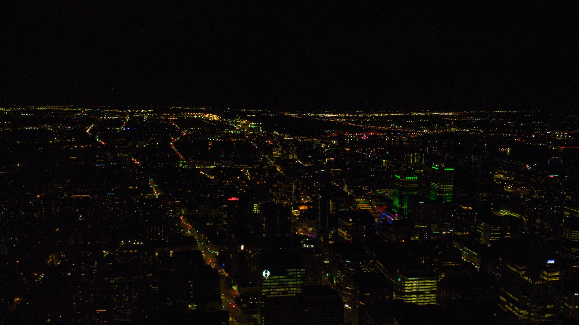 a view of a city at night from the top of a building