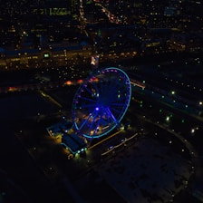 an aerial view of a ferris wheel at night