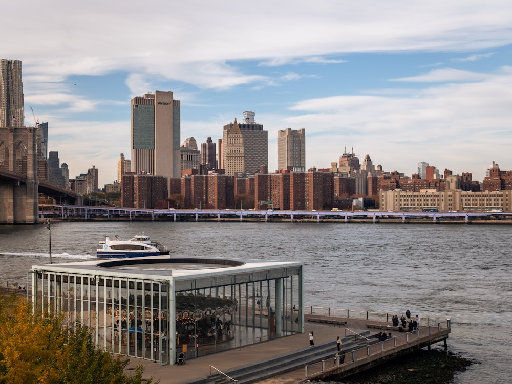 a boat is docked at a pier in front of a large city