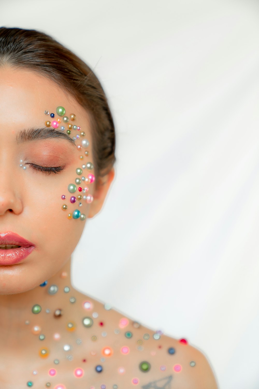 a woman with a lot of beads on her face