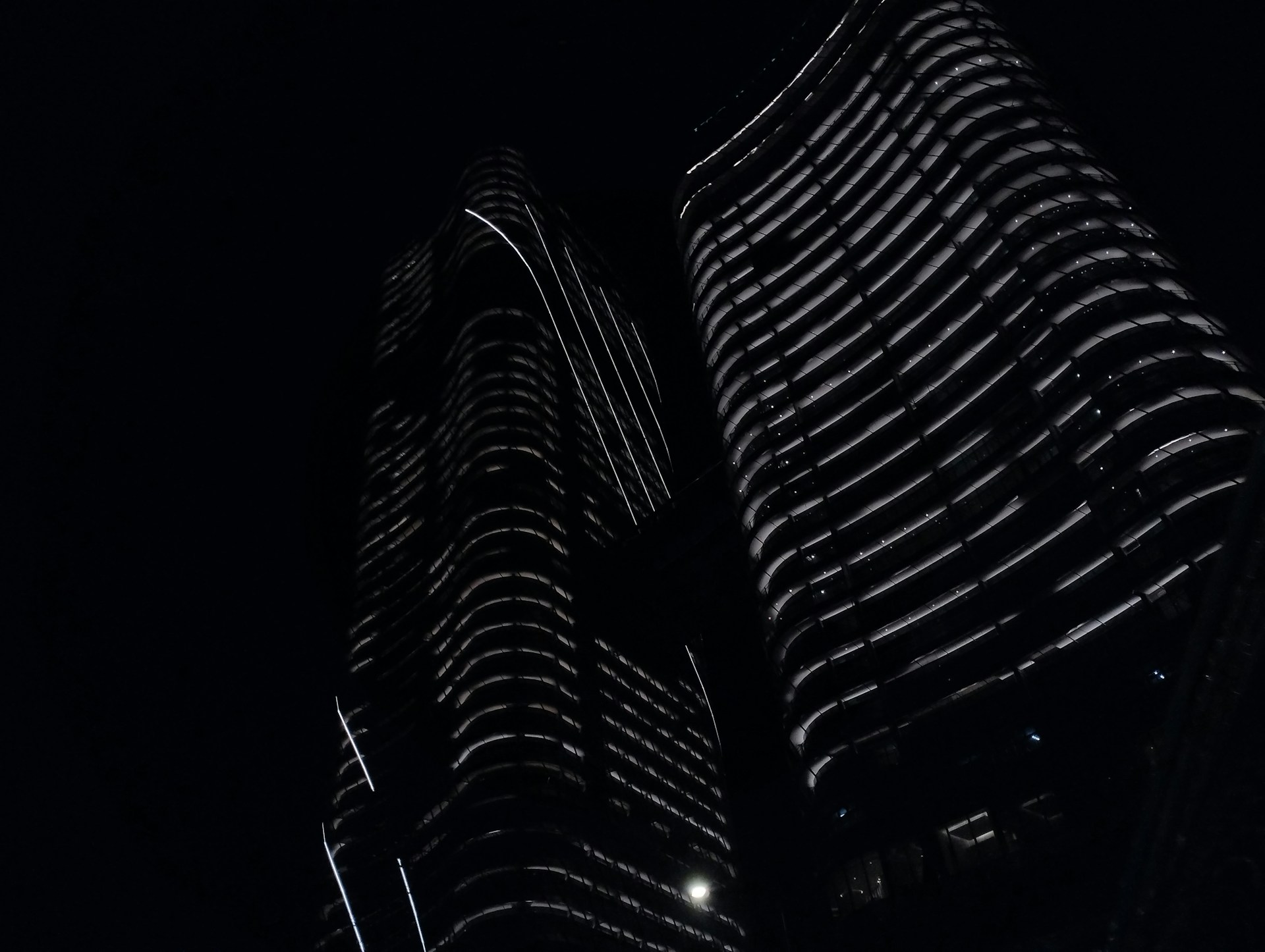 a black and white photo of two tall buildings