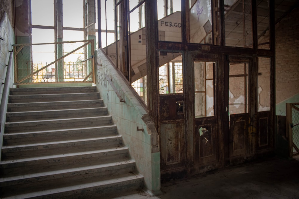a set of stairs in a run down building