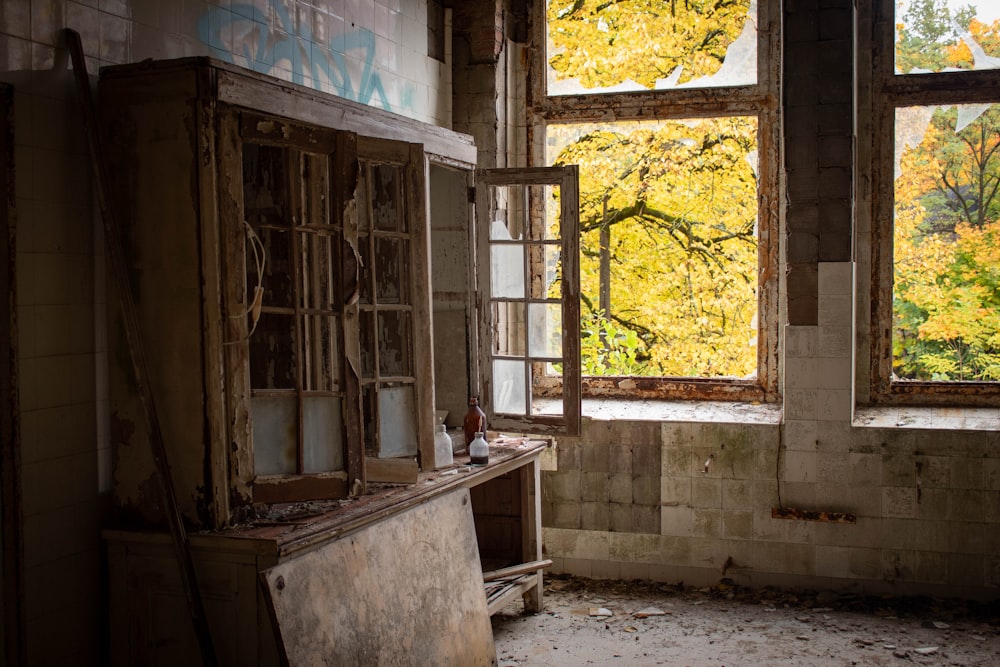 a run down room with a broken window