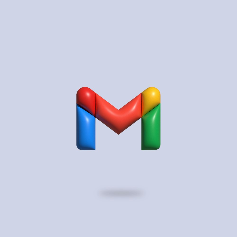 the letter m is made up of colorful shapes